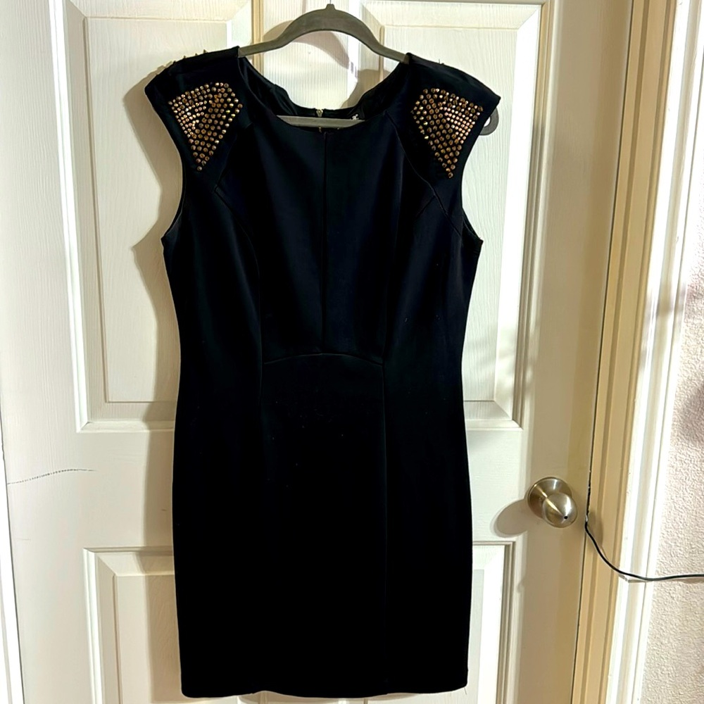 Black sleeveless dress with bronze spikes on shoulder back zipper